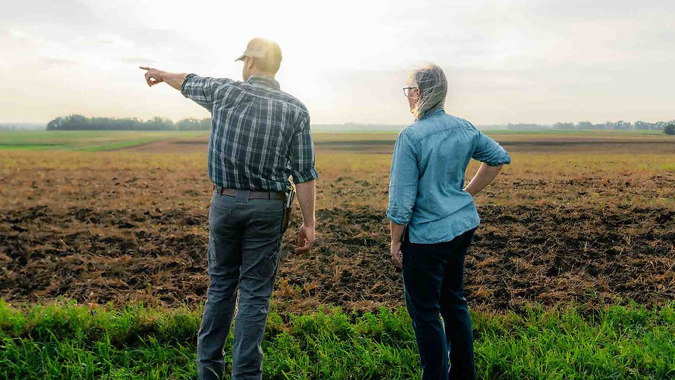 South Dakota Congressional candidate Sheryl Johnson listens as a farmer points across his